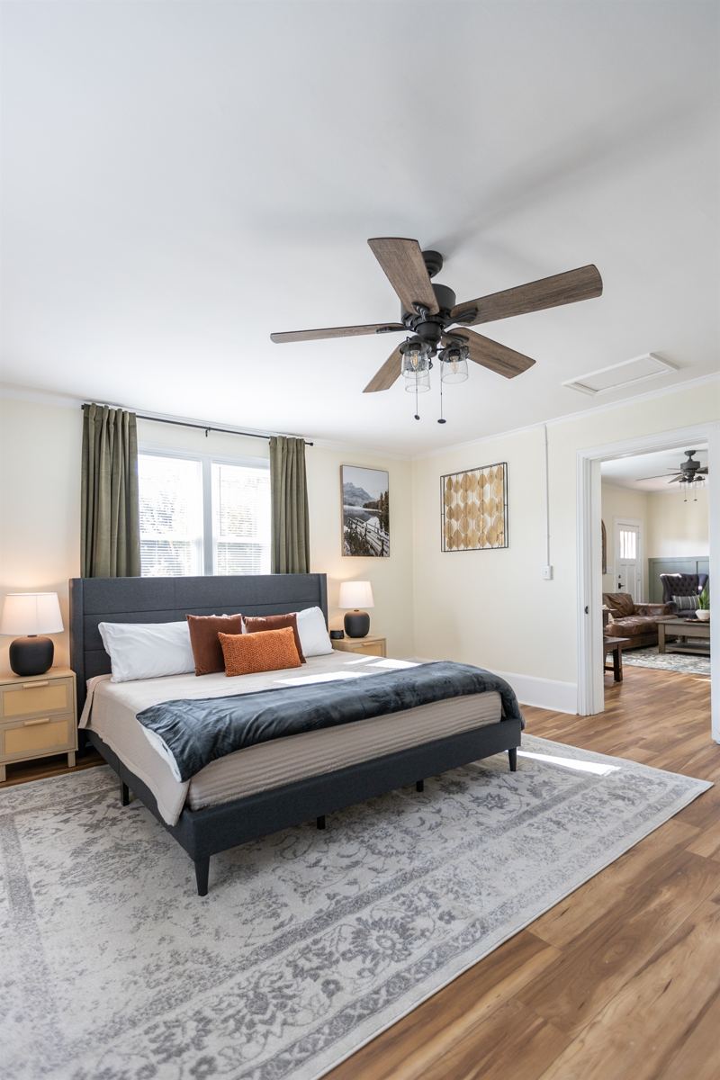 Main House Bottom Floor Unit Bedroom #2 with King Bed, En-Suite Bathroom, 55 inch adjustable ROKU TV, Sound Machine & Blackout Curtains.