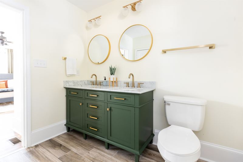 Main House Bottom Unit En-Suite Bathroom #2 with oversized rainfall shower head and handheld shower feature, tub and double vanity.