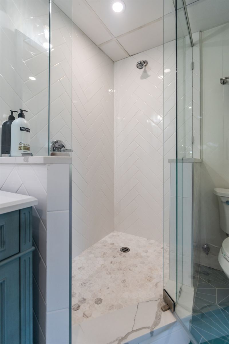 Studio Unit spacious bathroom with extra-large shower, full-size washer/dryer with detergent provided.