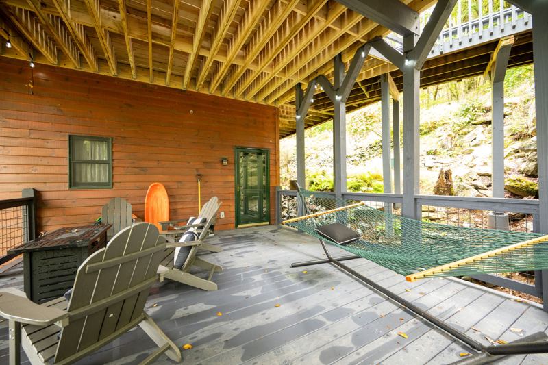 Under deck fun with a hammock, fire table and cozy chairs