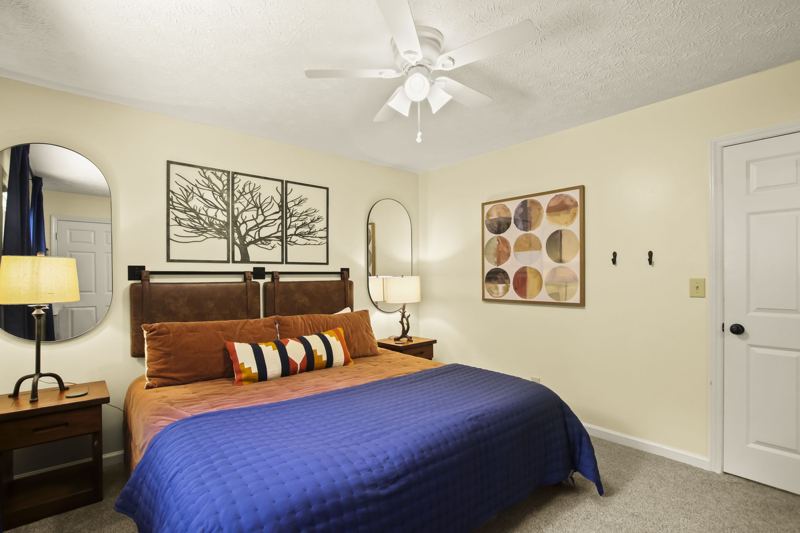 Main Level Bedroom (Fall Room) with King Bed, 43-inch Smart TV, large dresser, room darkening curtains, white noise machine and luggage rack.