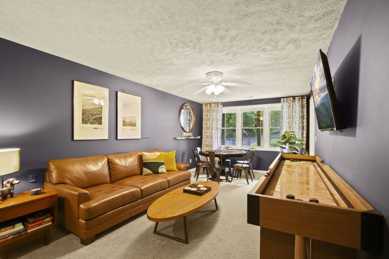 Downstairs game area with poker, shuffleboard and foosball tables, lots of board games for all ages.