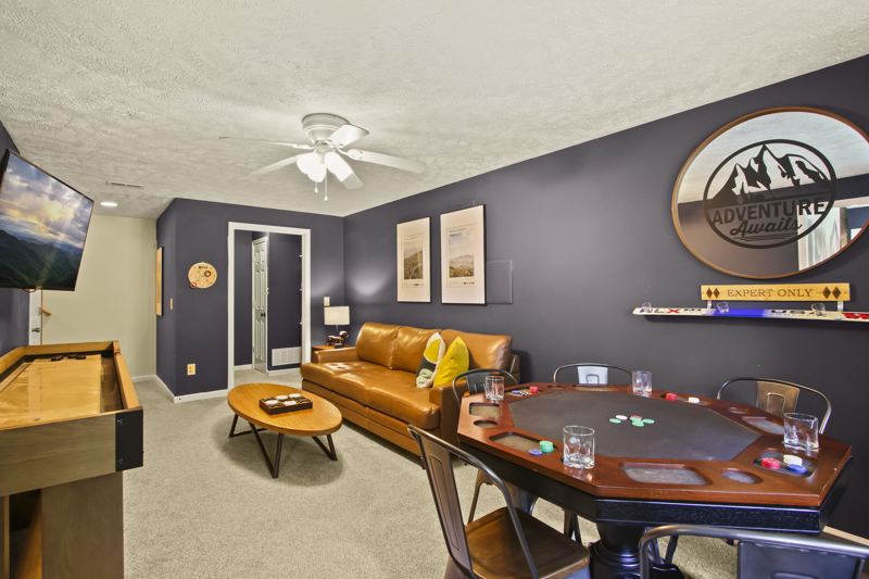 Downstairs game area with poker, shuffleboard and foosball tables, lots of board games for all ages.