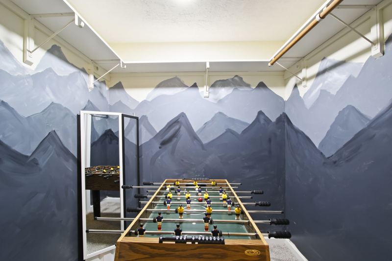 Downstairs game area with poker, shuffleboard and foosball tables, lots of board games for all ages.