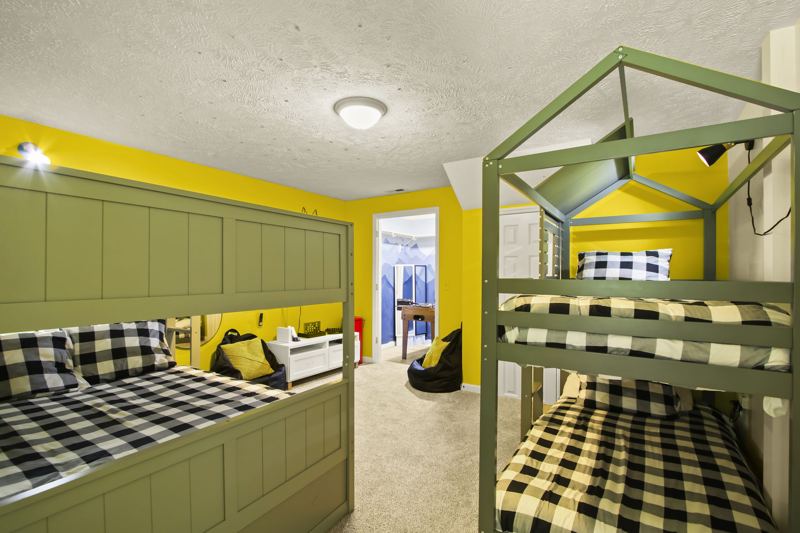 Lower-Level Bedroom with Two (2) Full Bunkbeds, two (2) Twin Bunkbeds, Twin Trundle, 50-inch Smart TV, blackout curtains and white noise machine.