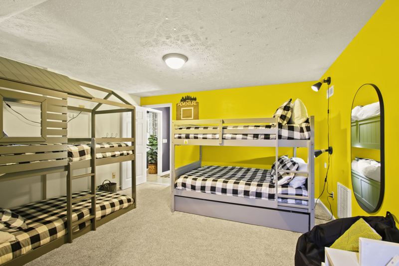 Lower-Level Bedroom with Two (2) Full Bunkbeds, two (2) Twin Bunkbeds, Twin Trundle, 50-inch Smart TV, blackout curtains and white noise machine.