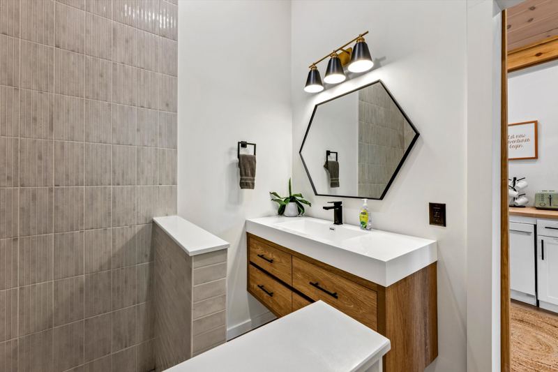 Rainfall shower with hand-held ceiling skylight and provided shampoo/conditioner/body wash.