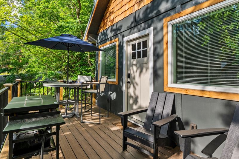 Deck with Blackstone Grill, cafe lights, bistro table and sitting chairs