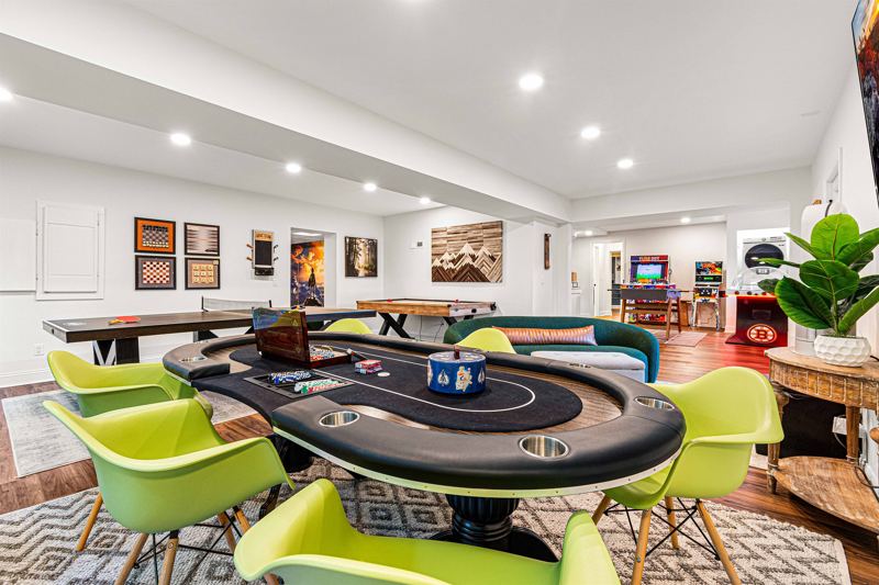 Entire Lower Level is the Game Room - complete with 8-Person Poker Table, Air Hockey, Ping Pong, Foosball, Bubble Hockey, 5,000+ Game Arcade Machine, 55-inch TV, and retractable sliding doors to still be one with nature.
