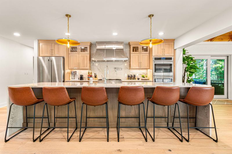Seating for 8 at the expansive waterfall kitchen island