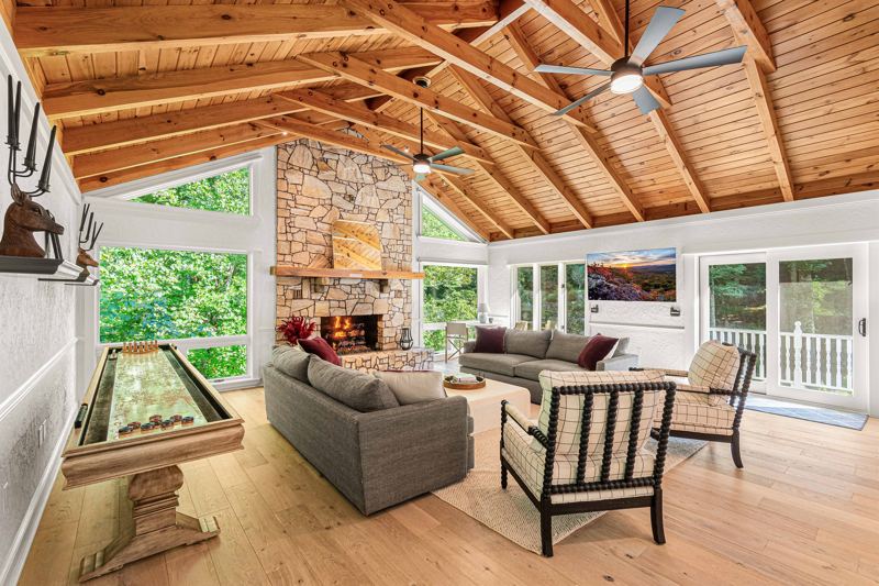 East Great Room with gas fireplace, 65-inch Smart TV, Shuffleboard Table and views of the Waterfall!