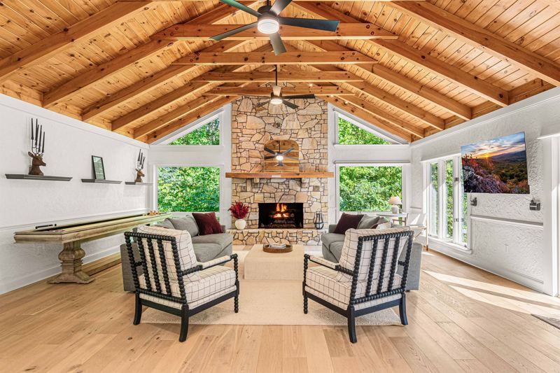 East Great Room with gas fireplace, 65-inch Smart TV, Shuffleboard Table and views of the Waterfall!