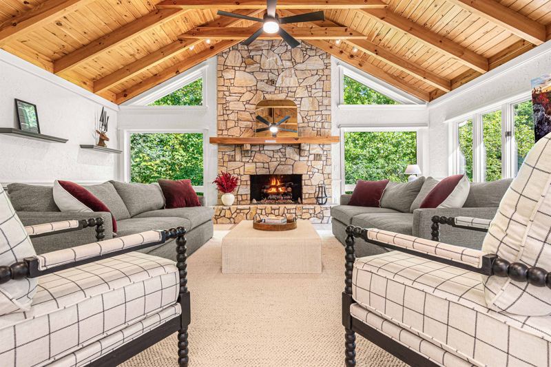 East Great Room with gas fireplace, 65-inch Smart TV, Shuffleboard Table and views of the Waterfall!