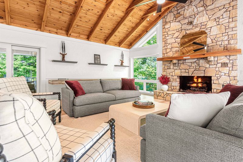 East Great Room with gas fireplace, 65-inch Smart TV, Shuffleboard Table and views of the Waterfall!