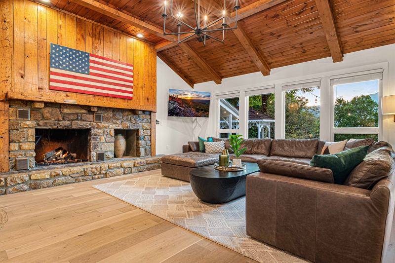 West Great Room with gas fireplace, 65-inch Smart TV and extra-large lounge sofa.