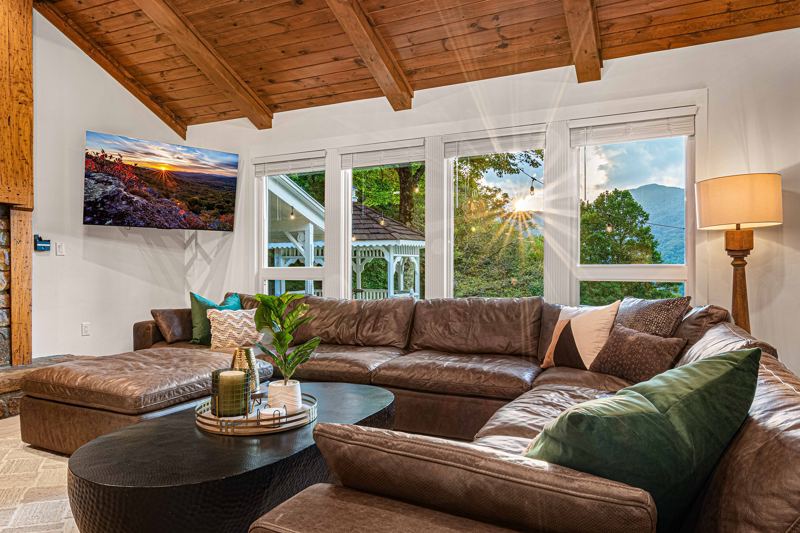 West Great Room with gas fireplace, 65-inch Smart TV and extra-large lounge sofa.