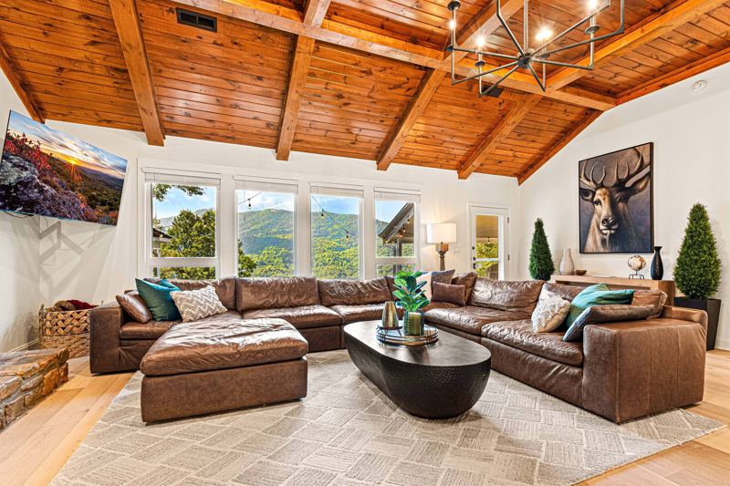 West Great Room with gas fireplace, 65-inch Smart TV and extra-large lounge sofa.