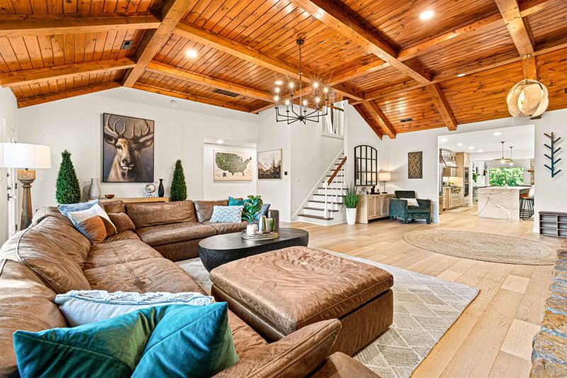 West Great Room with gas fireplace, 65-inch Smart TV and extra-large lounge sofa.