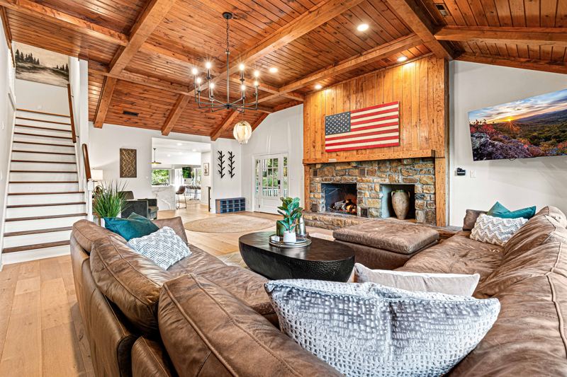 West Great Room with gas fireplace, 65-inch Smart TV and extra-large lounge sofa.