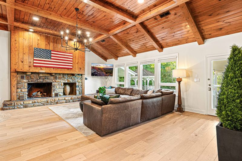 West Great Room with gas fireplace, 65-inch Smart TV and extra-large lounge sofa.
