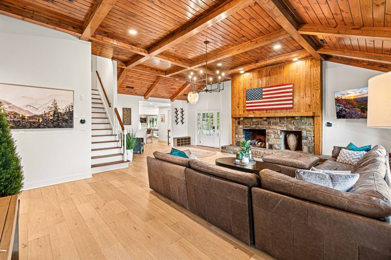 West Great Room with gas fireplace, 65-inch Smart TV and extra-large lounge sofa.