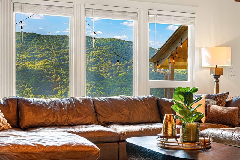 West Great Room with gas fireplace, 65-inch Smart TV and extra-large lounge sofa.
