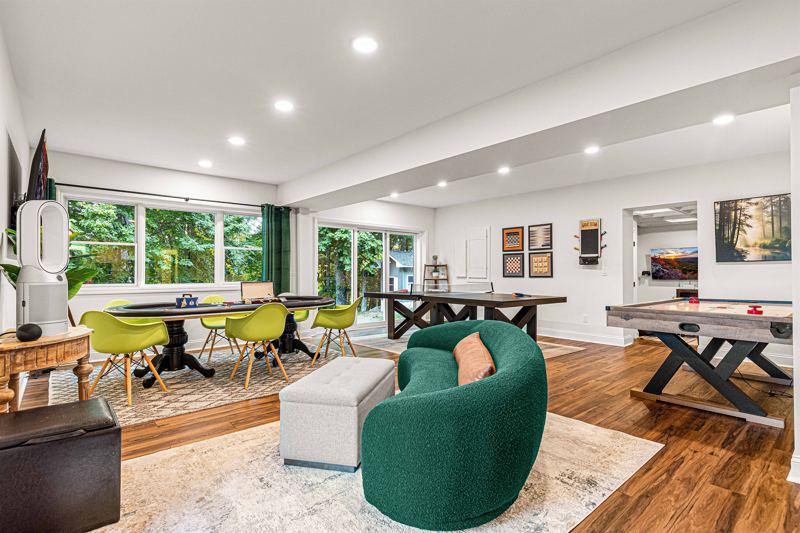 Entire Lower Level is the Game Room - complete with 8-Person Poker Table, Air Hockey, Ping Pong, Foosball, Bubble Hockey, 5,000+ Game Arcade Machine, 55-inch TV, and retractable sliding doors to still be one with nature.