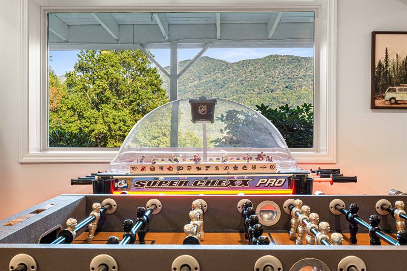 Entire Lower Level is the Game Room - complete with 8-Person Poker Table, Air Hockey, Ping Pong, Foosball, Bubble Hockey, 5,000+ Game Arcade Machine, 55-inch TV, and retractable sliding doors to still be one with nature.