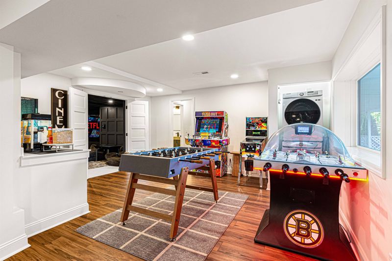 Entire Lower Level is the Game Room - complete with 8-Person Poker Table, Air Hockey, Ping Pong, Foosball, Bubble Hockey, 5,000+ Game Arcade Machine, 55-inch TV, and retractable sliding doors to still be one with nature.