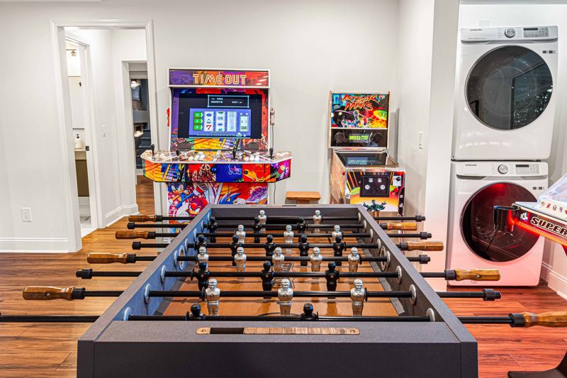 Entire Lower Level is the Game Room - complete with 8-Person Poker Table, Air Hockey, Ping Pong, Foosball, Bubble Hockey, 5,000+ Game Arcade Machine, 55-inch TV, and retractable sliding doors to still be one with nature.