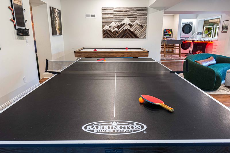 Entire Lower Level is the Game Room - complete with 8-Person Poker Table, Air Hockey, Ping Pong, Foosball, Bubble Hockey, 5,000+ Game Arcade Machine, 55-inch TV, and retractable sliding doors to still be one with nature.
