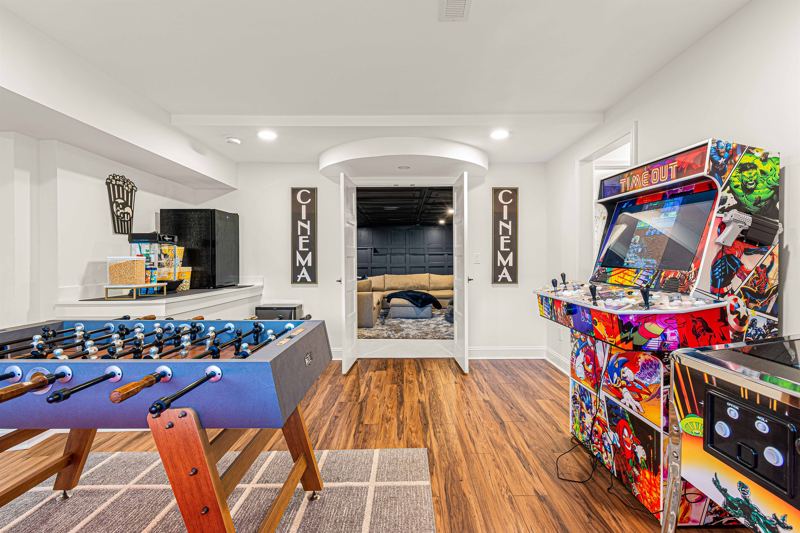 Entire Lower Level is the Game Room - complete with 8-Person Poker Table, Air Hockey, Ping Pong, Foosball, Bubble Hockey, 5,000+ Game Arcade Machine, 55-inch TV, and retractable sliding doors to still be one with nature.