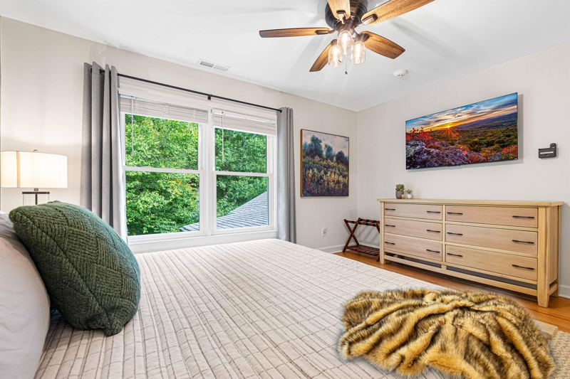 Upper-Level Bedroom #1 with King Bed, Double Closet, 55-inch Smart TV, Blackout Curtains, Sound Machine and Dresser.