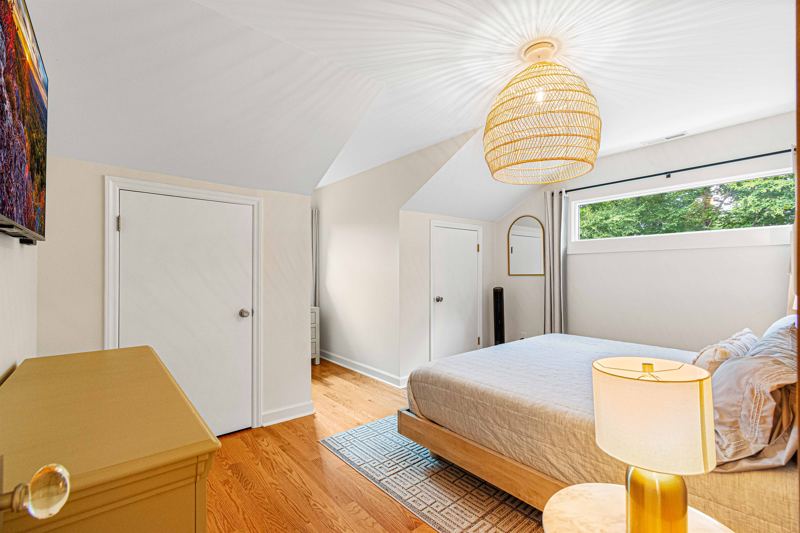 Upper-Level Bedroom #2 with King Bed, Double Closet, 55-inch Smart TV, Blackout Curtains, Sound Machine and Dresser.