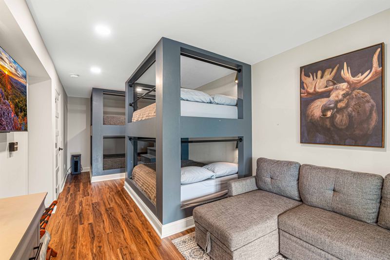 Lower- Level Queen Built-In Bunk Room with 55-inch Smart TV, Individual Reading lights by each bed and Dresser