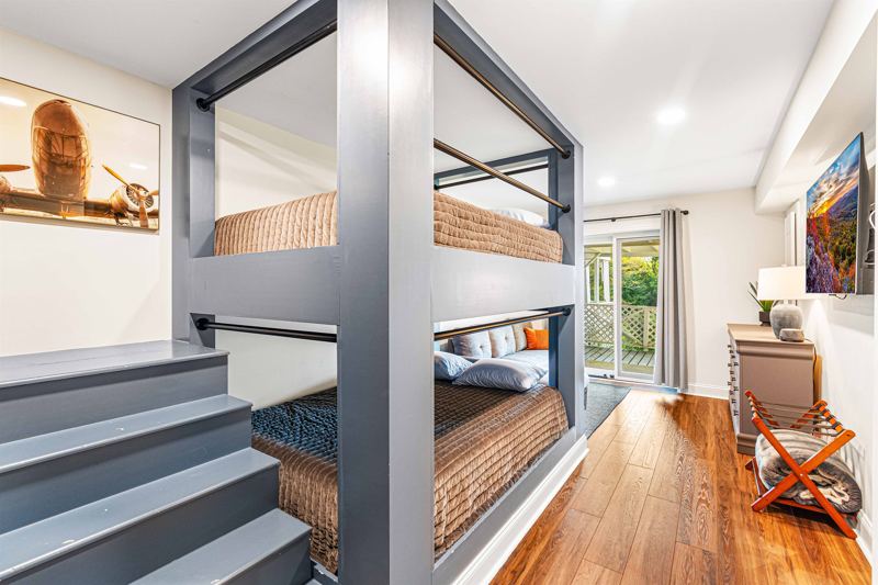 Lower- Level Queen Built-In Bunk Room with 55-inch Smart TV, Individual Reading lights by each bed and Dresser