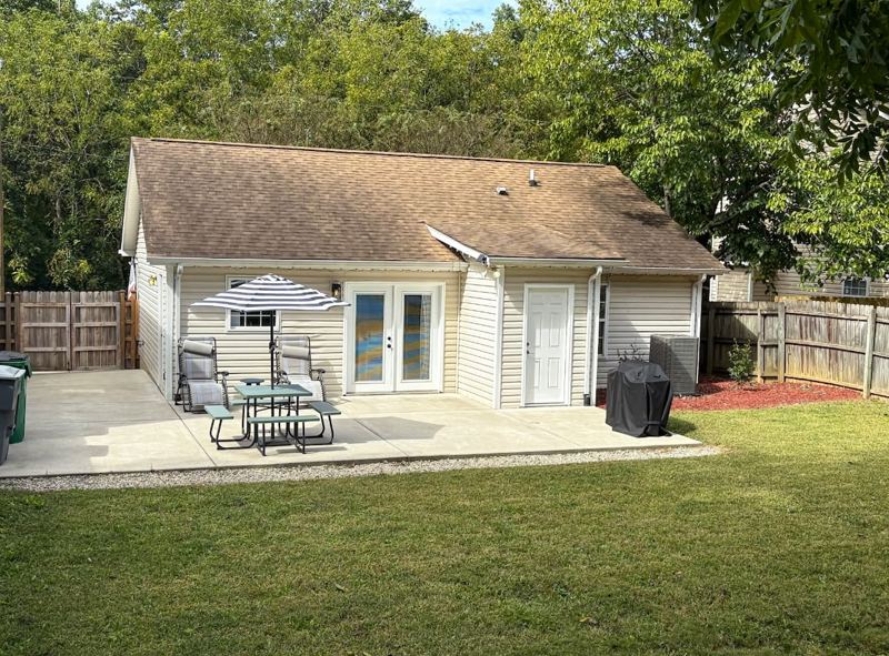 Private outdoor space with new fence, grill, and string lights for ambiance!