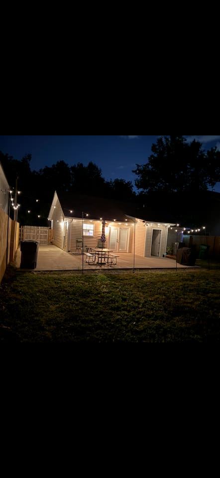 Private outdoor space with new fence, grill, and string lights for ambiance!