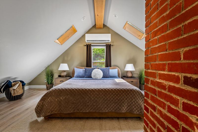 The Penthouse: Master Bedroom with King Bed, 42-inch Smart TV, Fireplace, sound machine, blackout curtains and cozy reading chair.