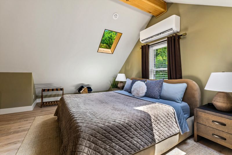 The Penthouse: Master Bedroom with King Bed, 42-inch Smart TV, Fireplace, sound machine, blackout curtains and cozy reading chair.