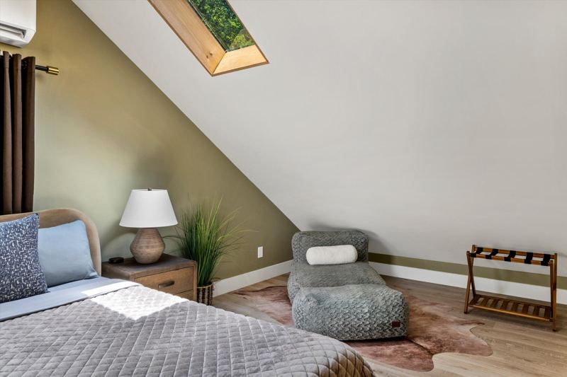 The Penthouse: Master Bedroom with King Bed, 42-inch Smart TV, Fireplace, sound machine, blackout curtains and cozy reading chair.