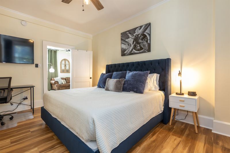 Bottom Unit Bedroom #1 with King Bed, En-Suite Bathroom, Work station with desk, lamp and monitor, 55 inch adjustable ROKU TV, Sound Machine & Blackout Curtains.