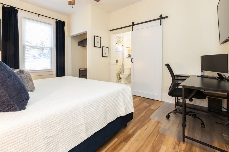 Bottom Unit Bedroom #1 with King Bed, En-Suite Bathroom, Work station with desk, lamp and monitor, 55 inch adjustable ROKU TV, Sound Machine & Blackout Curtains.
