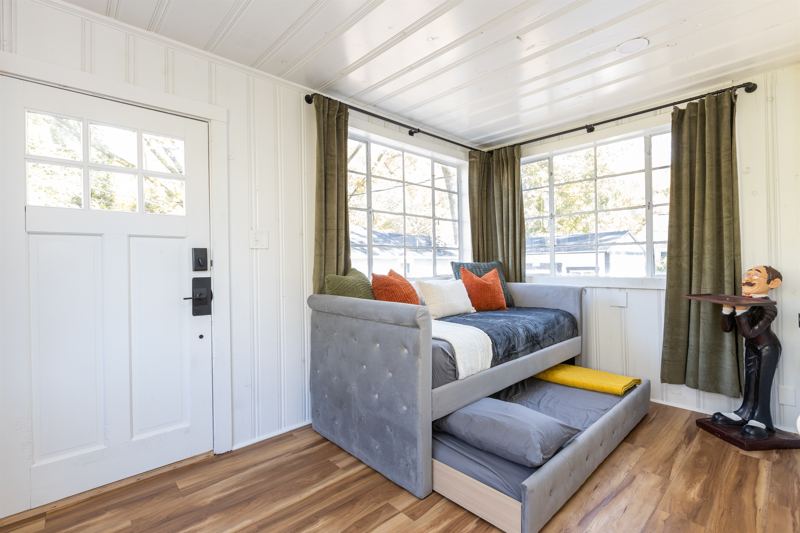 Bottom Floor Sunroom with Trundle Bed with Twin XL Mattress on top and Twin Mattress on the bottom, Blackout Curtains along all windows and sound machine