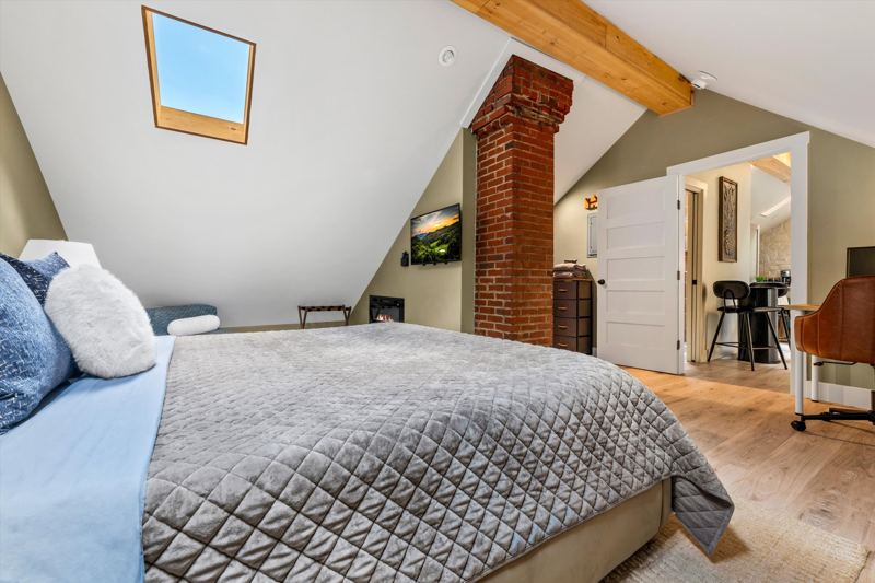 Master Bedroom with King Bed, 42-inch Smart TV, Fireplace, sound machine, blackout curtains and cozy reading chair