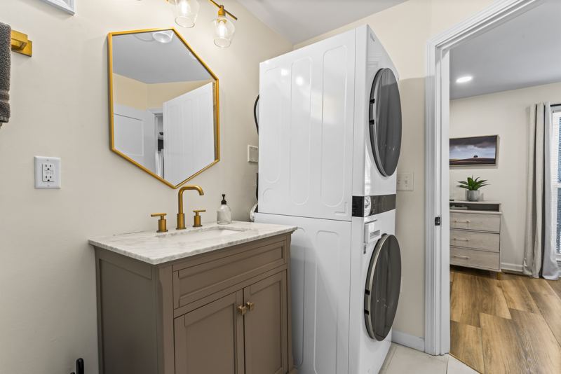 Ensuite bathroom with washer/dryer and expansive shower