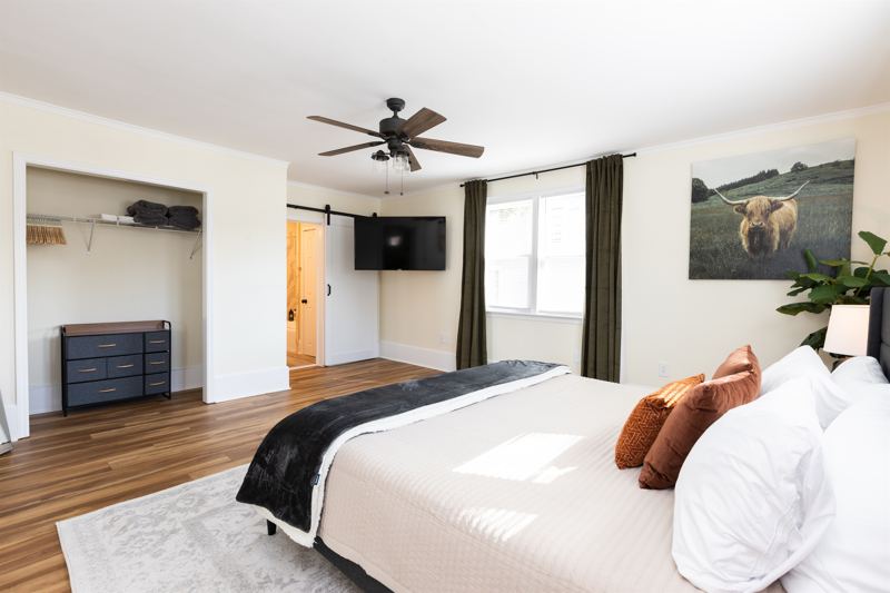 Main House Bottom Floor Unit Bedroom #2 with King Bed, En-Suite Bathroom, 55-inch adjustable ROKU TV, Sound Machine & Blackout Curtains.