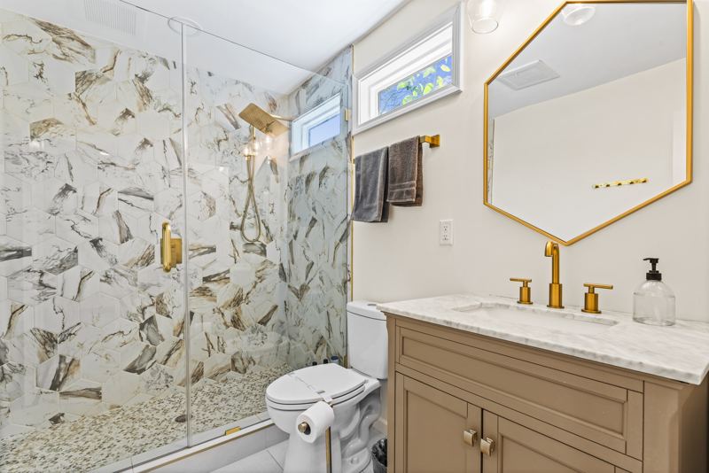Back Unit 1 bed/1 bath extra-large walk-in shower with rainfall shower head and handheld features, window to let in natural light, large mirror and vanity.
