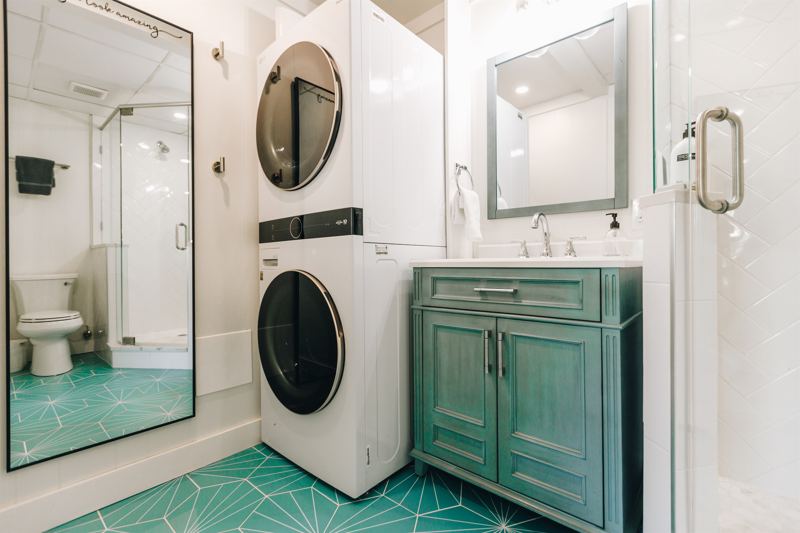 Studio Unit Bathroom with full size washer/dryer, full length mirror and provided detergent.